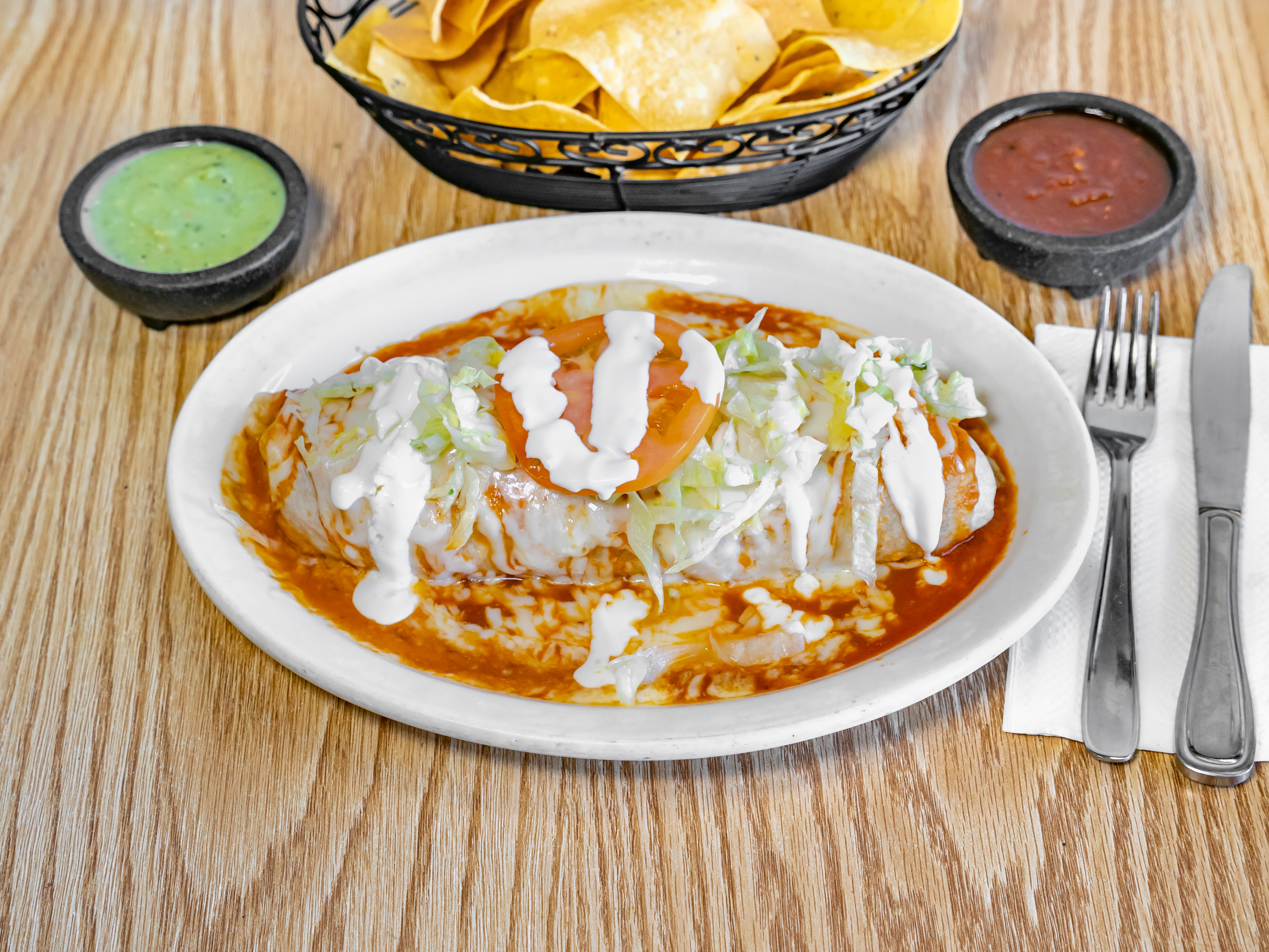 Burrito Mojado topped with red sauce