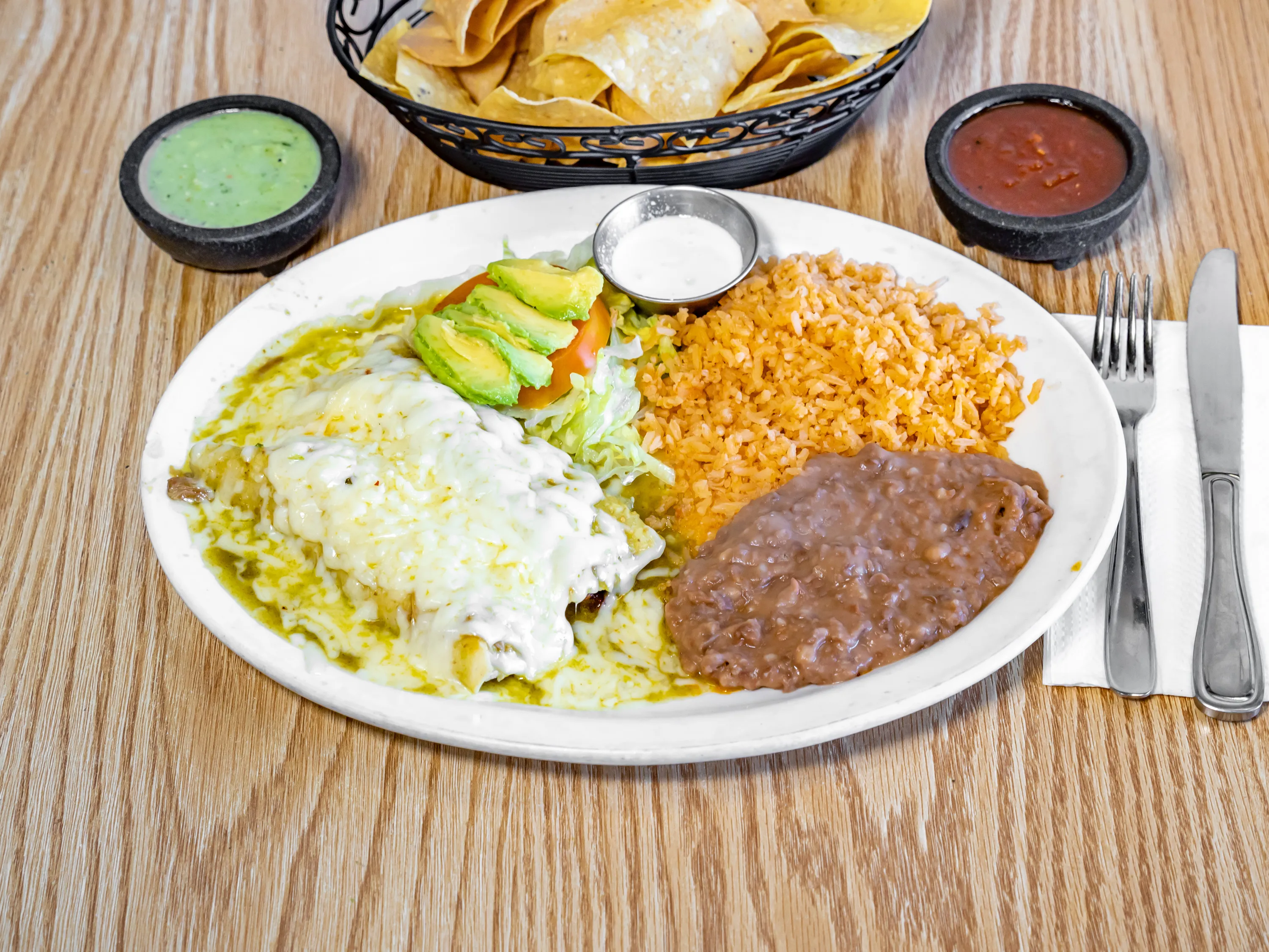 Green enchiladas plate with rice and beans