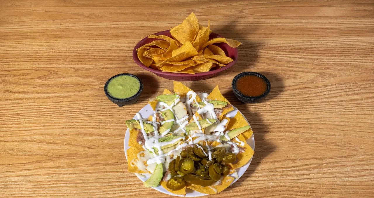 Plate of nachos with melted cheese