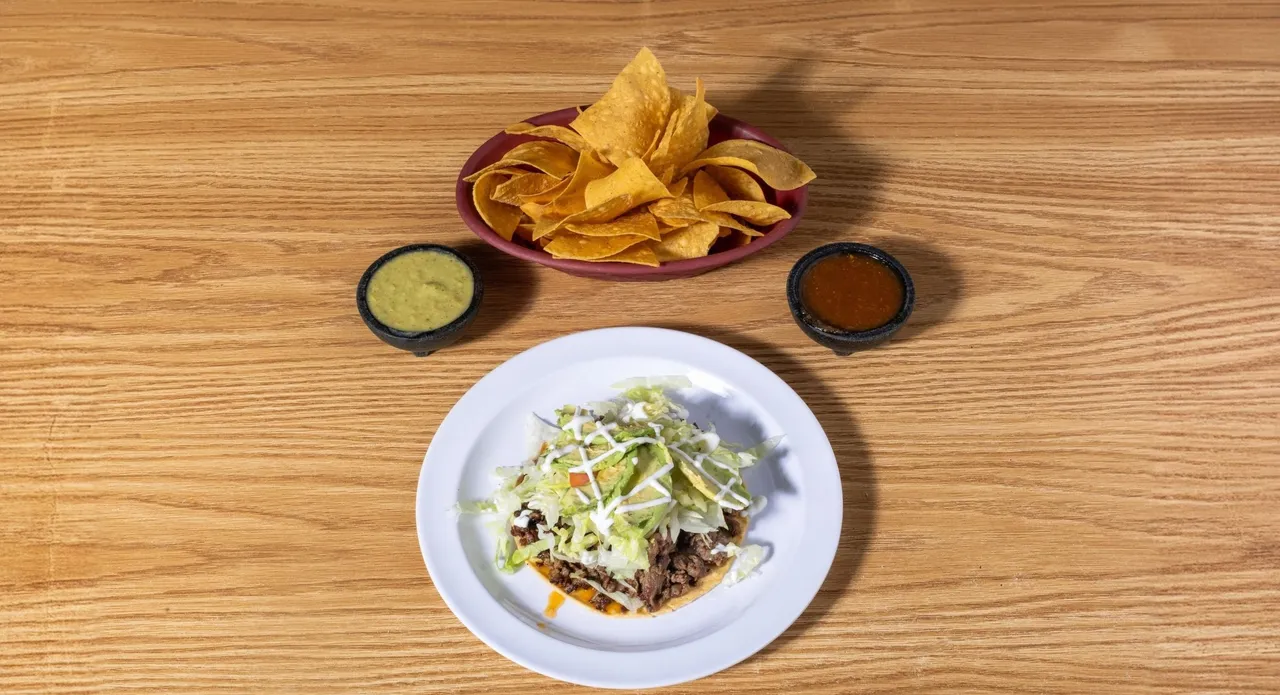 Tostada with beans, lettuce, salsa and cheese